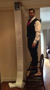 Rajinder holding up a copy of his record-breaking love poem