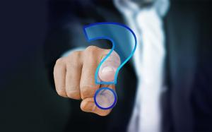Finger touching a blue question mark