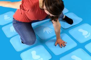 Woman playing hands and feet hopscotch