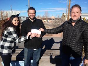 $10,000 winner Anthony Kneisser receives his check from Great U.S. Treasure Hunt organizer Jeff Kessler, who traveled to Santa Fe to award the prize