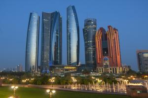 Skyscrapers of Abu Dhabi at night with Etihad Towers buildings. Abu Dhabi is the capital and the second most populous city of the United Arab Emirates.