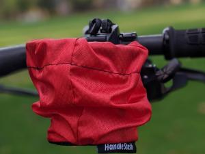 HandleStash cup holder in red color mounted to a bike handlebar