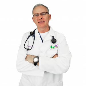 Dr. Gerstenberg of gerstenberg.clinic in a white doctor's coat with arms crossed.