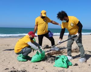 Volunteers from the Scientology Center of Tel Aviv help clean tar from a nearby beach after last week’s oil spill.