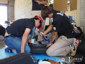 Kogakuin University Solar Team engineers make adjustments ahead of the Bridgestone World Solar Challenge in 2019.