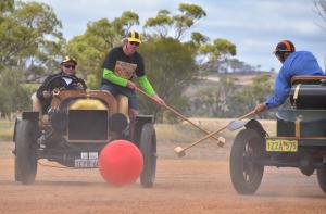 Hitting the ball while playing Autopolo with Ford Model T speedsters