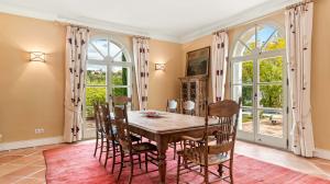 Linger around the breakfast nook or enjoy the formal dining room with French doors leading to the terrace dripping in wisteria for a magical indoor/outdoor experience.
