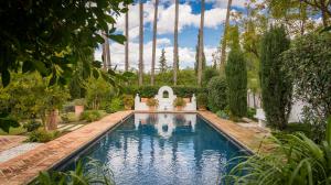 Entertain outdoors in the cobblestone secret garden or around the blue-tiled swimming pool.