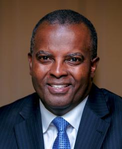 a head and shoulder photograph of a man in jacket and tie