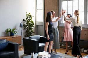 Women coming together and highfiving