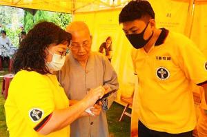 Buddhist monk makes use of modern electronic and spiritual technology by adding a link to the Volunteer Ministers online courses to a smartphone.