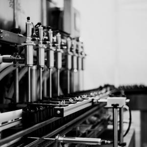 Black and white image showing PetDine's liquid supplement manufacturing set up.
