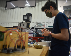 Student building their prototypes as part of the Tatawwar program