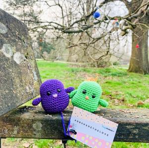 Two knitted birds sat on a bench for the Oxford craft bomb