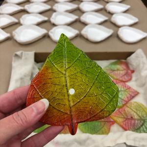 One of 200 colourful cast glass aspen leaves for the Frasier Retirement Donor Appreciation Wall