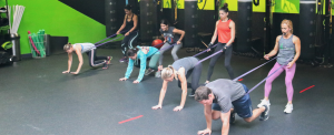 A coach helps Pulse Fitness HP members to level up their fitness.