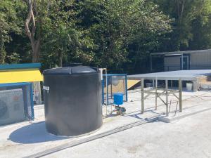 Roof-mounted water tank on concrete roof