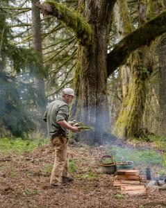 Forager Goods & Company founder chef Karl Holl cooks a foraged meal over an open fire.