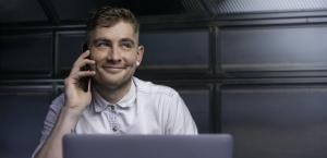 Smiling customer talking to virtual receptionist on phone