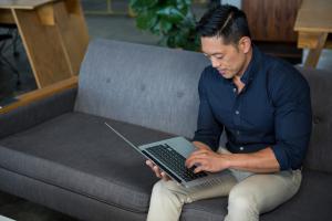 Man on laptop on couch