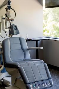 Transcranial Magnetic Stimulation treatment room with patient reclining chair