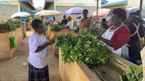 AgUnity Kenya Vegetable Smallholder Farmers at Market Exchanging Produce