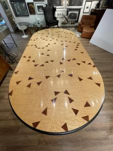 Dining table designed by Wendell Castle (American, 1932-2018), inlaid with purpleheart triangles and inlaid dots spelling "The Check's in the Mail” ($70,110).