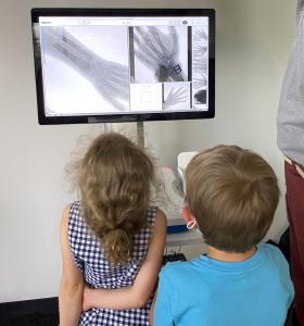 Two children looking at x-rays.