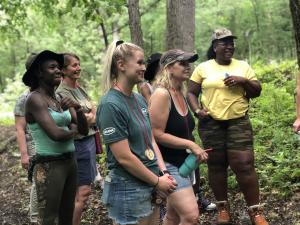 Women Bow Hunters in discussion in 3-D shooting range.