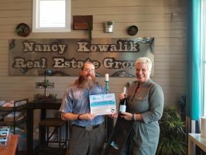 Nancy Kowalik presenting Ted Adams with his trip to the shore certificate