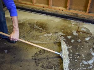 sweeping out sewage from pipe burst