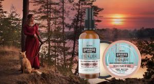 Woman warrior holding a bow with a fox standing at her feet while she stares off into the sunset. Valkyrie Edition Skin care Body Oil and Body Butter Balm made in Canada by Valhalla Legend.