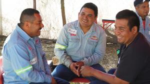 group of male workers talking and engaging