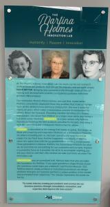 Wall display plaque describing the mission of The Martina Holmes Innovation Lab with three pictures of Martina Holmes at different ages.