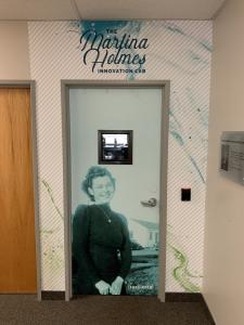 Image of the entrance to PetDine's Martina Holmes Innovation Lab with a black and white image of Martina Holmes covering the door.