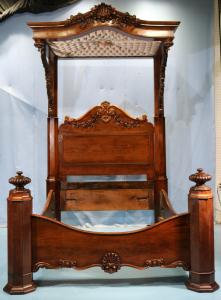 Rosewood rococo half tester plantation bed with roses carved on arm supports, attributed to P. Mallard. Estimate: $8,500-$15,000.