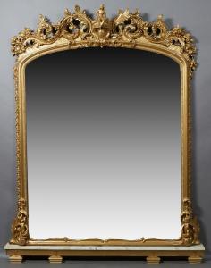 19th century American gilt and gesso Rococo Revival figural over-the-mantel mirror on a later white marble base, 96 inches tall. Estimate: $3,000-$5,000.