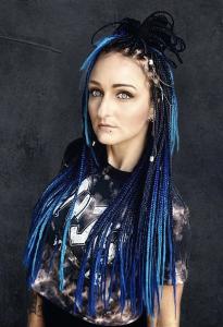Headshot of Aka V with black and blue dread locks.