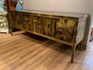 Just consigned, a Bernhard Rohne for Mastercraft bronze etched credenza with a brass panel top over three pair of hinged doors. Estimate: $3,000-$5,000.