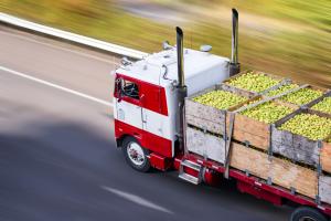The image is of an agricultural truck delivering produce.