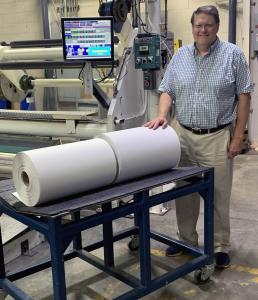David Gustafson, Marketing Manager For General Data’s Coated Products Division, stands with two coated rolls of Jet-Kote™ inkjet print-receptive material at General Data’s coating facility in Cincinnati, OH.