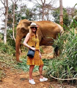 A rescued elephant accompanies Nicole in the Thai Jungle