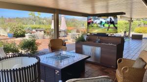 Just in time for socially distanced Football parties, this "Outdoor Mobile TV Lift Cabinet Bar & Fridge Stunner" that's a beautiful TV lift cabinet with built in bar and refrigerator on high-end casters so you can move it anywhere, makes entertaining easy