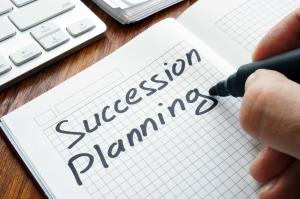Succession planning written on a note pad