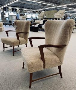 Organic form Modernist lounge chairs in a neutral sheepskin hue decorate a seating area in the main gallery.