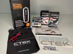 CTEK Battery Care Kit 1 including CTEK's popular MXS 5.0 charger, a protective bumper, the COMFORT CONNECT extension cable, and a COMFORT INDICATOR cig plug as well a CTEK static window cling and vinyl decals.