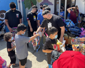 Boxing star Manny Pacquiao and family aid in the "education is power" campaign to provide local community school supplies