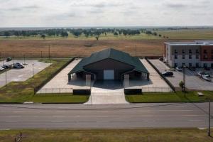 Luxury Real Estate in Perryton on Main St. -- 11,250± sq. ft on 1.248± acres  that is security fenced/gated -- Temperature controlled luxury shop that features kitchenette, living, office space, with 2 restrooms -- Covered parking