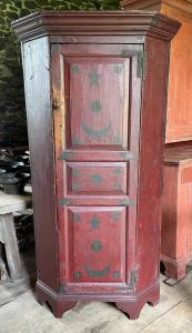 18th century star and moon paint-decorated corner cupboard.