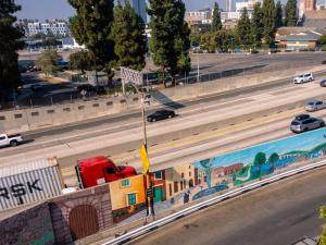 Hollywood’s Village mural on the barrier wall separating the 101 Freeway from on the north side of Hollywood